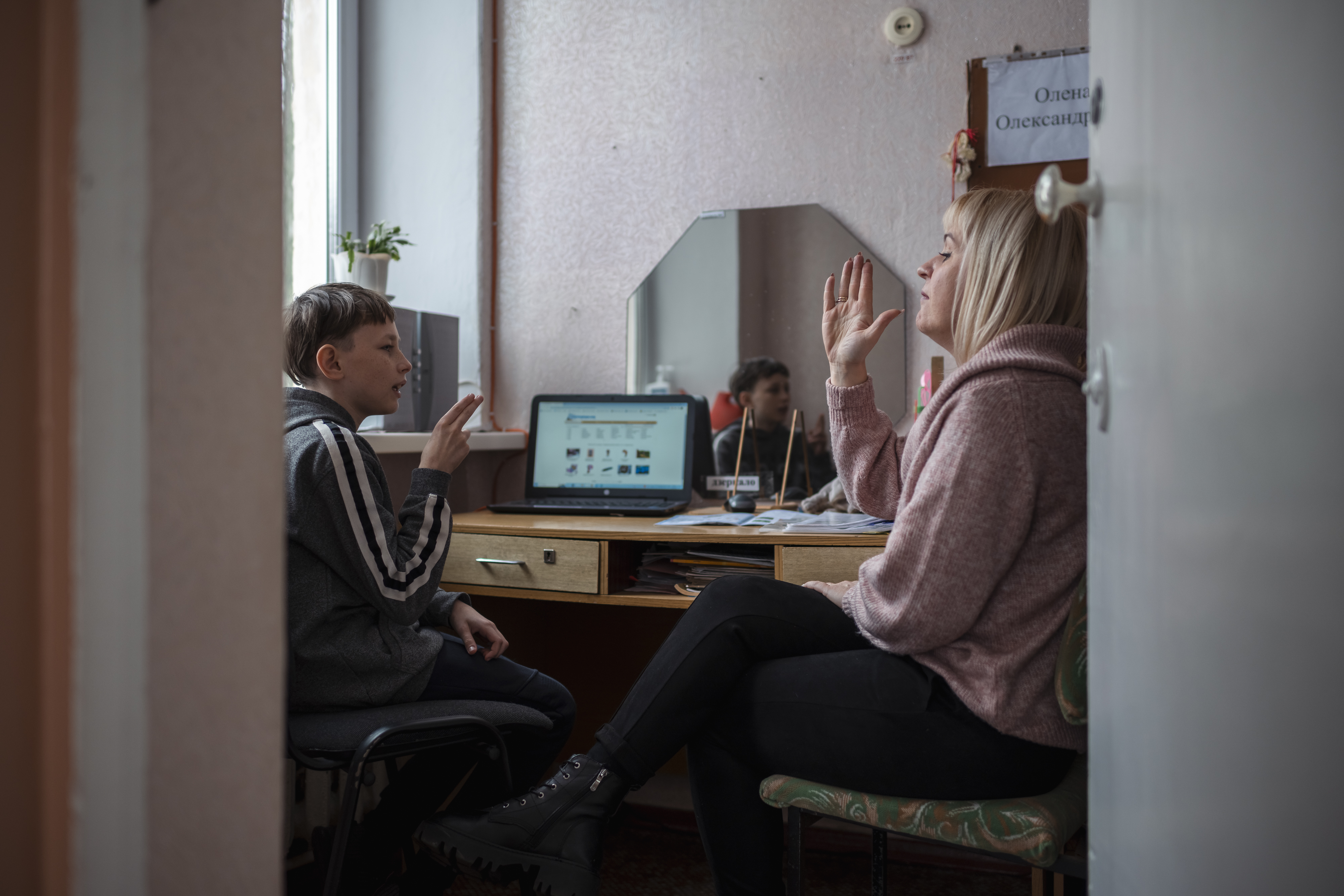 Ukrainian child studying with their teacher.